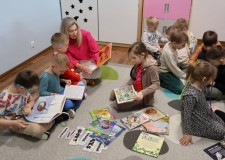 Powiększ zdjęcie Bibliotekarka%20prezentuje%20książkę%20popularnonaukową