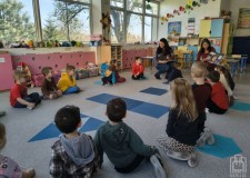 Powiększ zdjęcie Bibliotekarka czyta dzieciom książkę